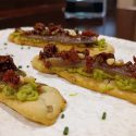 Sardina Anchoada sobre tosta de pipas, vinagreta de piñones y tomate seco